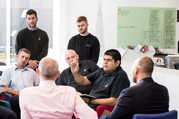REM employees occupying a modern office space while in discussion