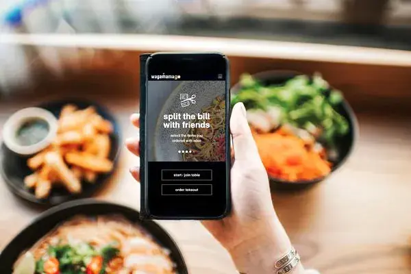 Front view of wagamamago app on mobile screen in wagamama restaurant