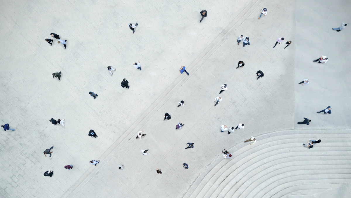 Overhead photograph of a busy square with people moving through